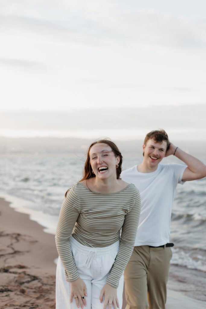 A couple laughing together on the beach 