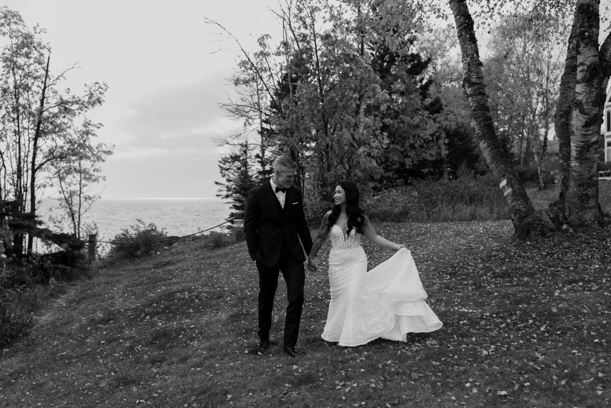 a couple taking wedding pictures on a hillside at Bluefin Bay in Tofte, MN